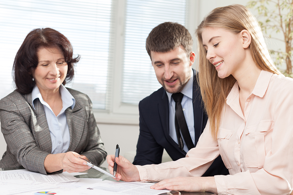 Photo of people reviewing a document - Aggressive Injury Lawyer